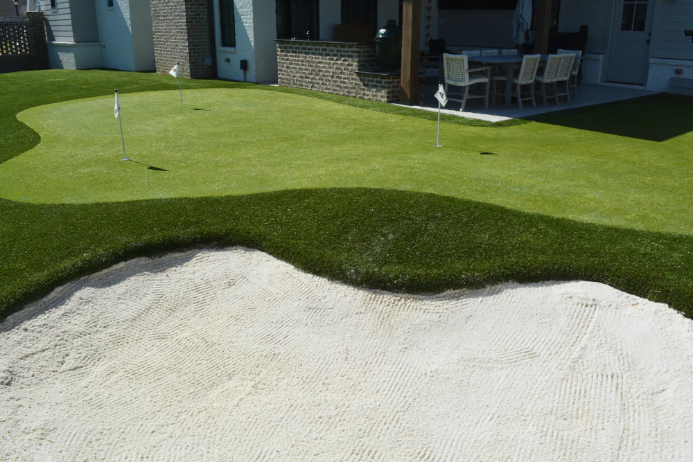 Backyard sand bunker over turf